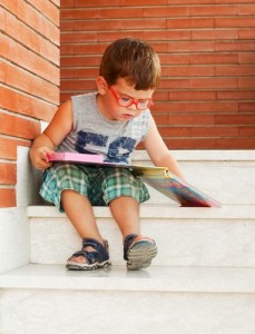 Boy Reading On Stoop