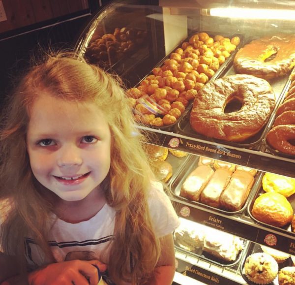 Sarah getting Texas sized round rock donut